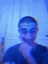 a blurry picture of a man making a funny face with a blue background