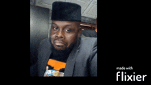 a man wearing a black hat and a suit is made with flixier software