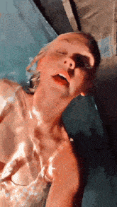 a woman with her eyes closed is in a pool