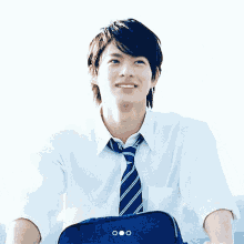 a young man wearing a tie and a white shirt