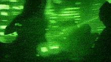 a silhouette of a person standing in front of a green background