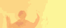 a person 's shadow is cast on a yellow wall