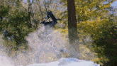 a person in a skeleton costume is jumping in the air with trees in the background