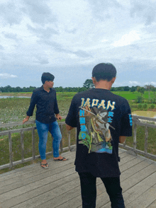 a man wearing a black shirt with the word japan on the back