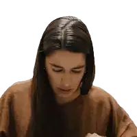 a woman wearing a brown sweater is looking down