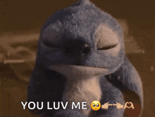 a stuffed animal says you luv me with a sad face