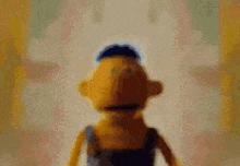 a close up of a puppet with a blue hat on