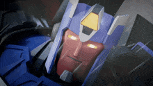 a close up of a robot 's face with glowing yellow eyes