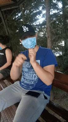 a man wearing a mask and a la hat