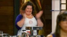 a woman wearing an apron with a m on it