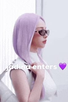 a woman with purple hair is wearing sunglasses and a white shirt with the words " jadina enters " written below her