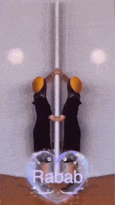 a person standing next to a pole with the word rabab written on it