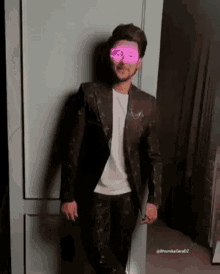 a man wearing a black suit and a white shirt is standing in front of a door with his eyes glowing pink