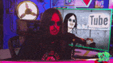 a man with long hair is sitting in front of a microphone in front of a youtube sign