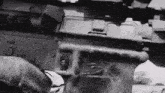 a black and white photo of a person holding a gun that says fire safe
