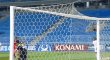 a soccer goal with a konami advertisement on the side