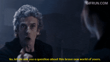 a gif from gifrun.com shows a man pointing at a woman