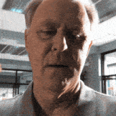 a close up of an older man 's face with his eyes closed