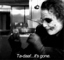 a black and white photo of the joker holding a knife and saying ta-daal ... it 's gone .