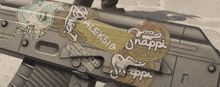 a close up of a gun with stickers on it including the word happi