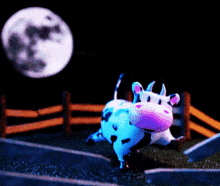 a cartoon cow with a pink nose is standing in front of a fence and a full moon