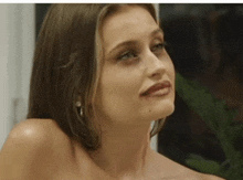 a close up of a woman 's face without a shirt