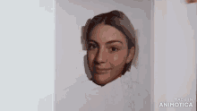 a painting of a woman 's face is being made in animoto