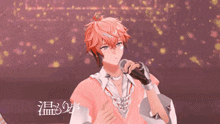 a man in a pink shirt is singing into a microphone with chinese writing on the bottom right corner