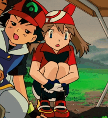 a boy and a girl are sitting under a tent and the girl is wearing a red hat with the letter a on it