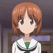a girl with brown hair and a green shirt with a cross