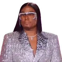 a man wearing sunglasses and a cross necklace