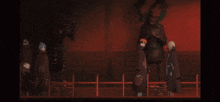 a group of people are standing in a dark room with a statue behind them
