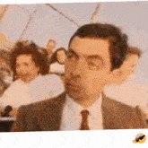 a man in a suit and tie is making a funny face with his eyes closed