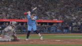 a baseball player swings his bat at a ball in front of a proud owner and fan banner
