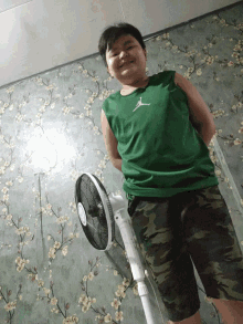 a boy wearing a green shirt with the word air on it