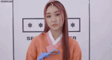 a girl with pink hair is standing in front of a sign that says sf on it
