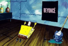 a cartoon of spongebob laying on the floor next to a poster that says beyonce
