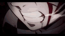 a close up of a person 's face with blood coming out of it and a smile .
