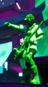 a man in a green hat is playing a guitar on a stage