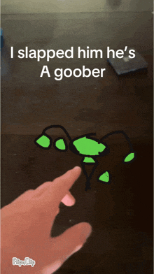 a person is pointing at a drawing of a goober