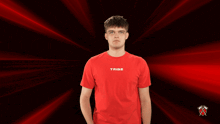 a man wearing a red shirt that says tribe on the front