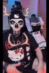 a person wearing a skull mask and a hello kitty hat