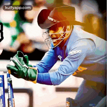 a cricket player wearing a helmet and gloves with an oppo shirt on