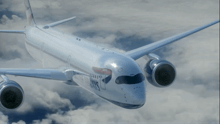a british airways plane is flying in the clouds