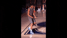 a basketball player stands on a court wearing a jersey that says nba on it