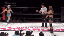two women in a wrestling ring with a sign that says world wonder stardom