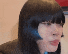 a close up of a woman 's face with a fringe