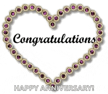 a heart made of purple stones with the words `` congratulations happy anniversary '' written on it .