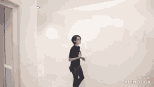 a woman standing in a white room with the words made in animatica on the bottom right