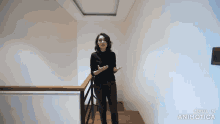 a woman is standing on a set of stairs with the words made in animatica on the bottom